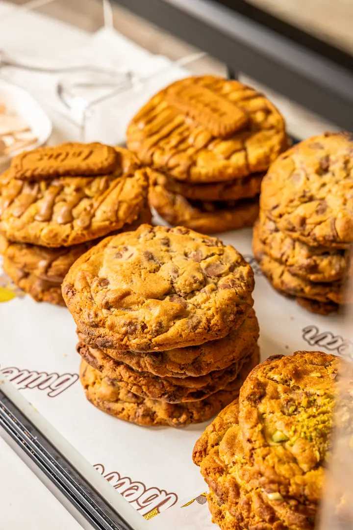 Stacks of Butter Bear cookies — Biscoff, milk chocolate chip and pistachio — in the display cabinet